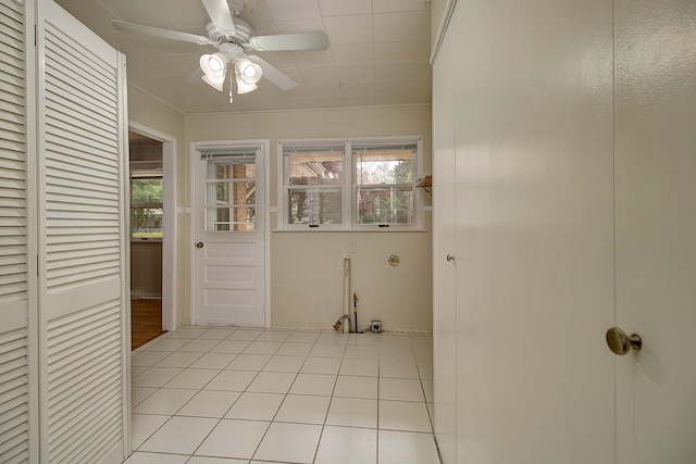 interior space featuring a healthy amount of sunlight, a ceiling fan, and light tile patterned flooring