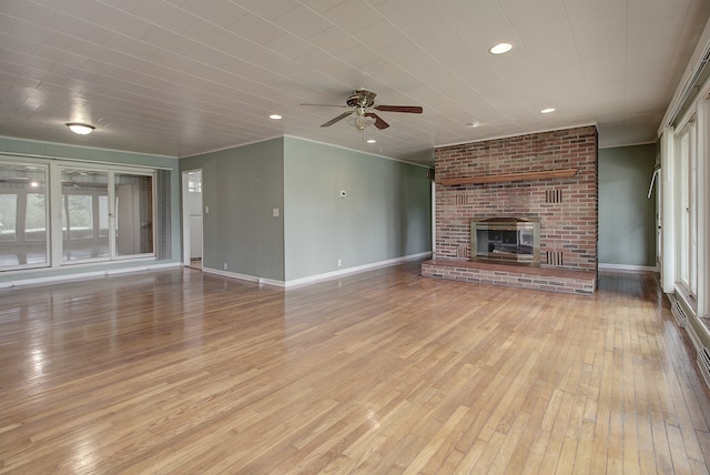 unfurnished living room with a ceiling fan, a brick fireplace, baseboards, recessed lighting, and hardwood / wood-style floors