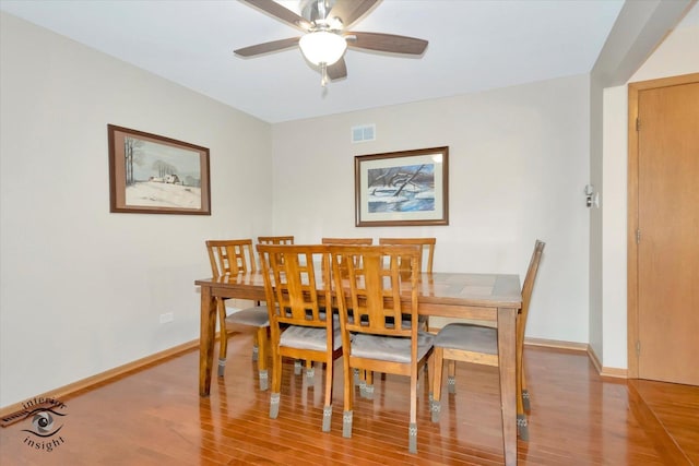 dining area featuring light wood-style floors, baseboards, and ceiling fan