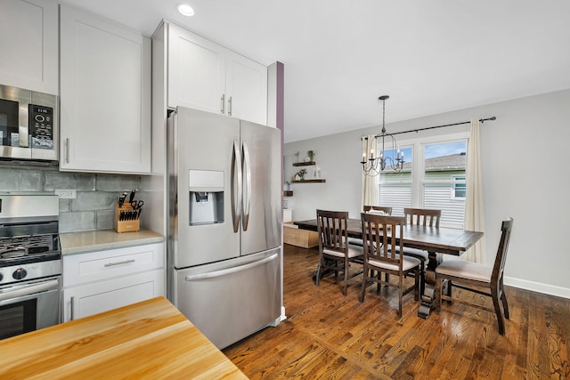 629 Sheffield Ln, Bolingbrook, IL 60440 - kitchen featuring white cabinetry, a chandelier, tasteful backsplash, hanging light fixtures, and stainless steel appliances