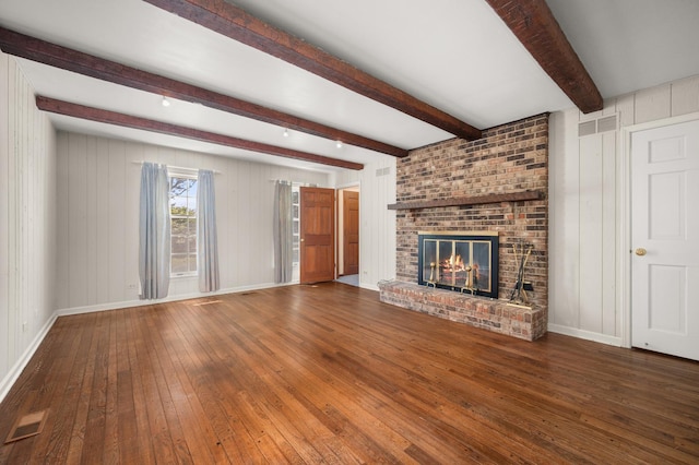 726 Parkside Dr, Sycamore, IL 60178 - unfurnished living room featuring hardwood / wood-style floors, beamed ceiling, a brick fireplace, and baseboards