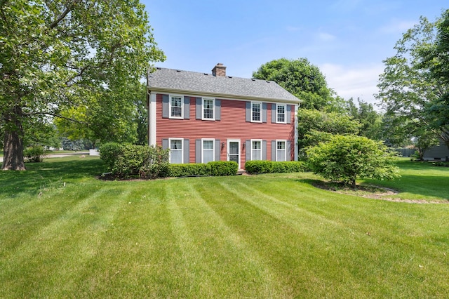 726 Parkside Dr, Sycamore, IL 60178 - colonial inspired home featuring a chimney and a front yard