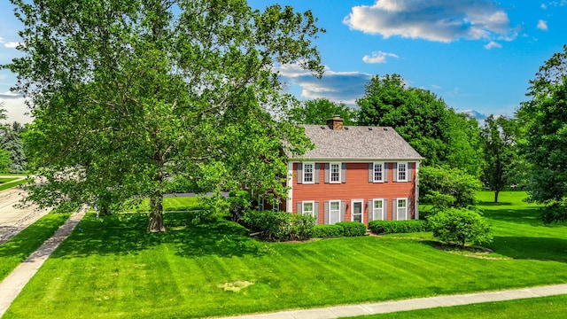 726 Parkside Dr, Sycamore, IL 60178 - colonial inspired home featuring a chimney and a front lawn
