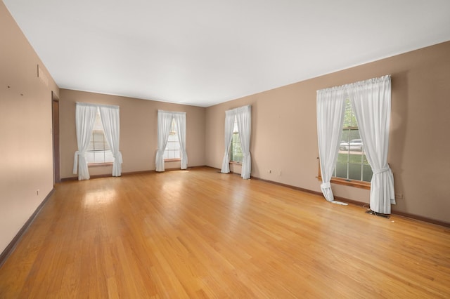 726 Parkside Dr, Sycamore, IL 60178 - unfurnished room featuring light wood-style floors, plenty of natural light, and baseboards