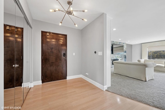 4000 Dundee Rd Unit 202C, Northbrook, IL 60062 - foyer featuring a chandelier, light wood-style floors, and baseboards