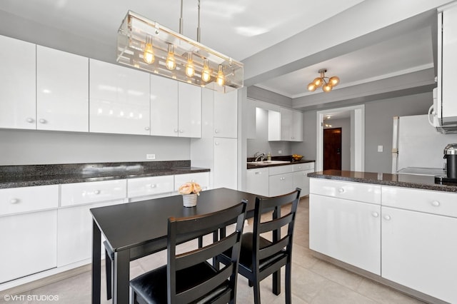 4000 Dundee Rd Unit 202C, Northbrook, IL 60062 - kitchen with freestanding refrigerator, white cabinets, a sink, and light tile patterned flooring