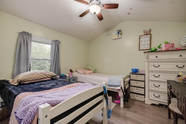bedroom featuring ceiling fan, vaulted ceiling, and wood finished floors