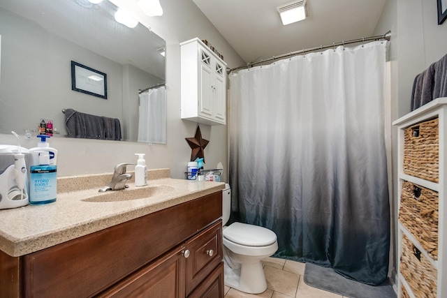 bathroom featuring toilet, tile patterned floors, and vanity
