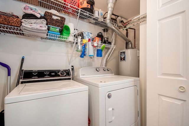 clothes washing area featuring water heater and independent washer and dryer
