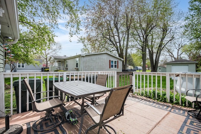 view of patio / terrace with a wooden deck, a residential view, and outdoor dining space