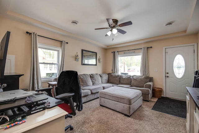 living room with plenty of natural light, ceiling fan, and light carpet