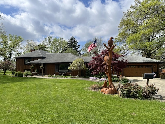 436 E Seminary Ave, Onarga, IL 60955 - view of grassy yard featuring an attached garage and concrete driveway