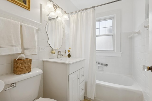 full bath with toilet, tile walls, vanity, and shower / bathtub combination with curtain
