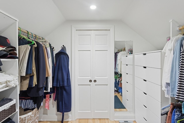 walk in closet featuring lofted ceiling