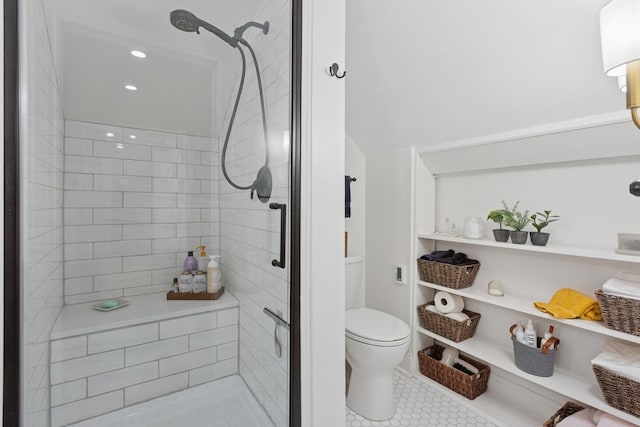 bathroom with toilet, a shower stall, and tile patterned floors