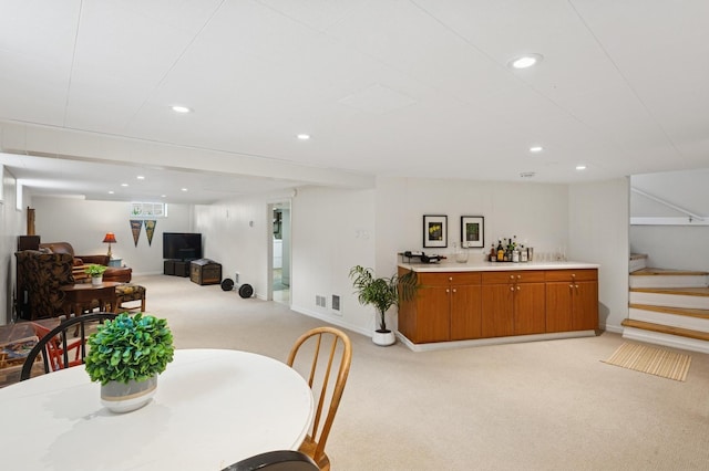 dining area featuring light colored carpet, visible vents, recessed lighting, stairway, and baseboards