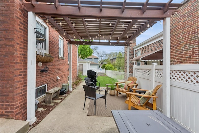 view of patio / terrace featuring a pergola and fence