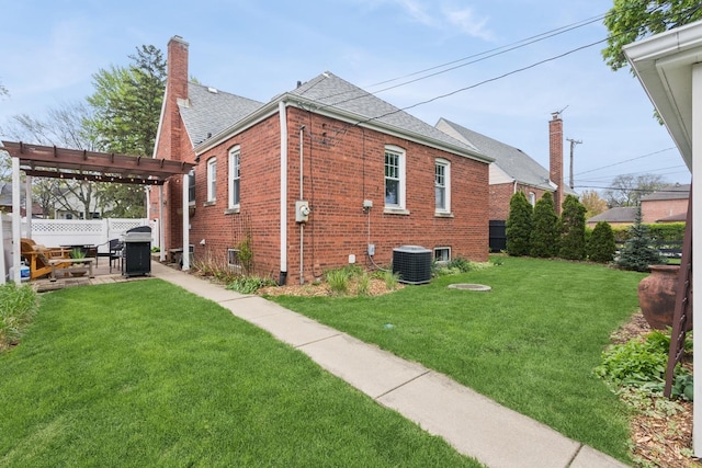 view of side of property featuring a lawn, brick siding, fence, central AC, and a pergola