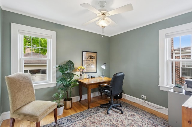 office area with plenty of natural light, wood finished floors, and baseboards