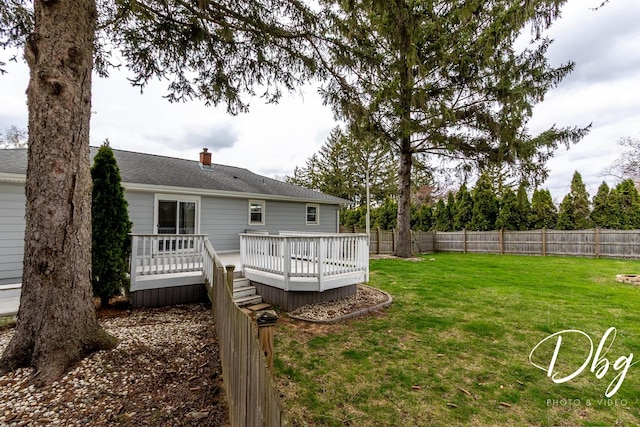 395 Magnolia Ave, Gurnee, IL 60031 - rear view of house with a yard, fence, a wooden deck, and a chimney