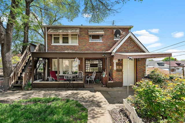 2335 N Merrimac Ave, Chicago, IL 60639 - back of house featuring brick siding, stairway, and a patio area