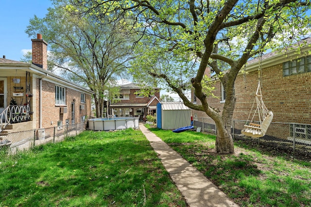 2335 N Merrimac Ave, Chicago, IL 60639 - view of yard featuring a storage unit, an outdoor pool, and an outbuilding