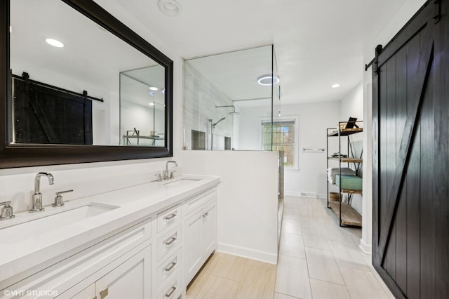 full bath featuring recessed lighting, walk in shower, double vanity, and a sink