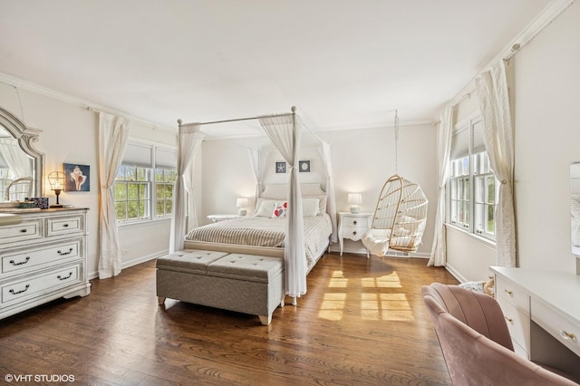 bedroom with baseboards, crown molding, and wood finished floors