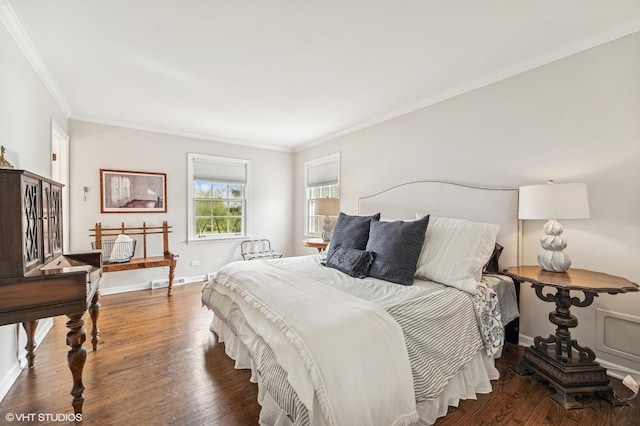 bedroom with wood finished floors, baseboards, and ornamental molding