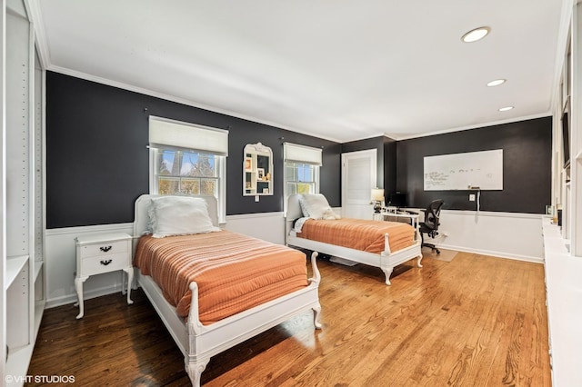 bedroom with crown molding, recessed lighting, baseboards, and wood finished floors