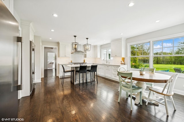 dining space featuring baseboards, recessed lighting, and dark wood-type flooring