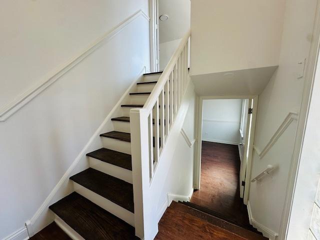 stairway featuring wood finished floors