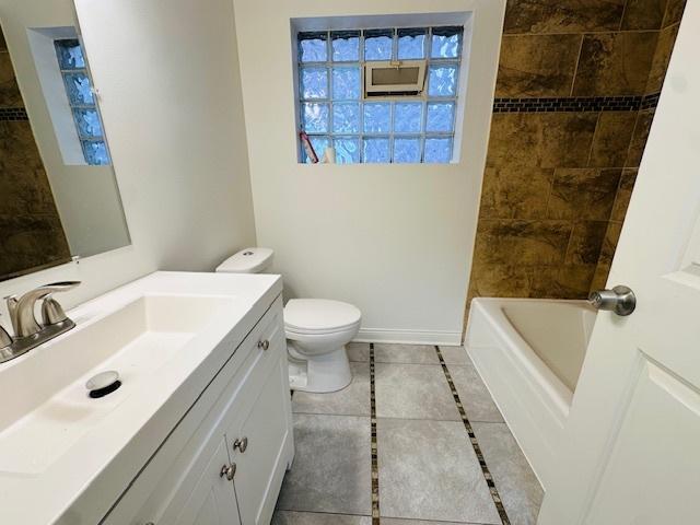 full bathroom featuring toilet, tile patterned flooring, and vanity