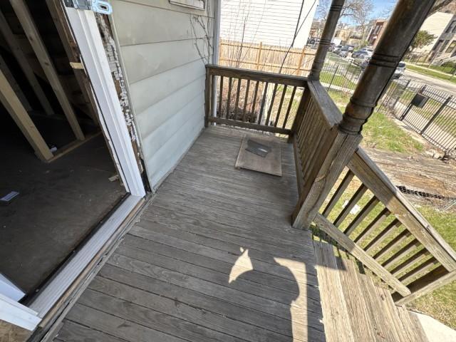 wooden terrace featuring fence