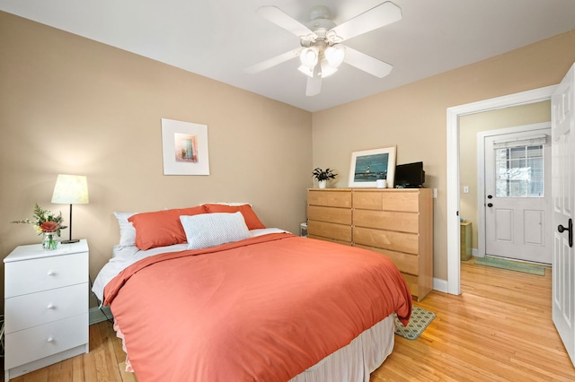 bedroom with baseboards, a ceiling fan, and light wood-type flooring