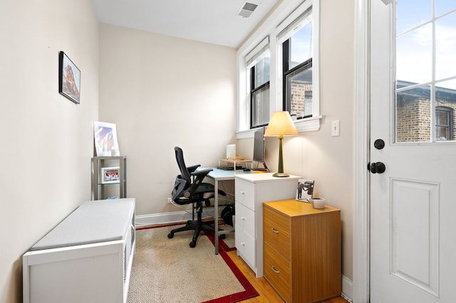 office space featuring visible vents, baseboards, and light wood-type flooring