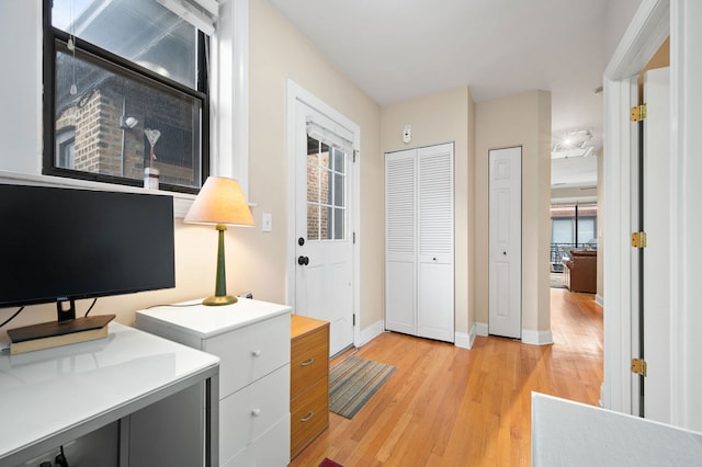 home office featuring baseboards and light wood-style floors