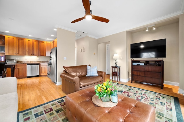 living room featuring crown molding, ceiling fan, baseboards, and light wood finished floors