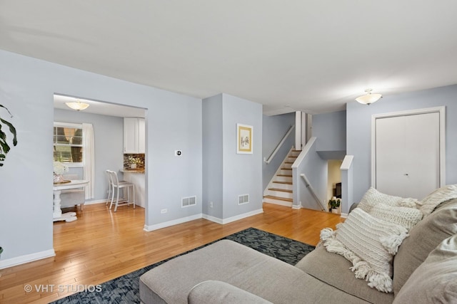 69 N Idlewild Ave, Mundelein, IL 60060 - living room with light wood-style floors, stairway, and baseboards