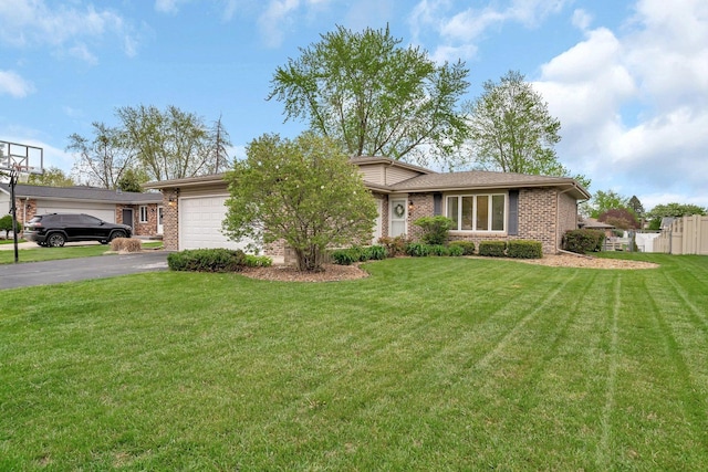 ranch-style house with aphalt driveway, a garage, brick siding, and a front yard
