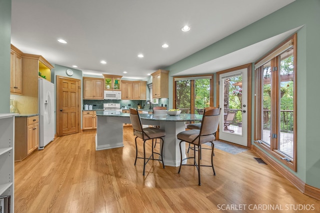 645 Rosewood Dr, West Chicago, IL 60185 - kitchen featuring white appliances, plenty of natural light, a breakfast bar area, and recessed lighting