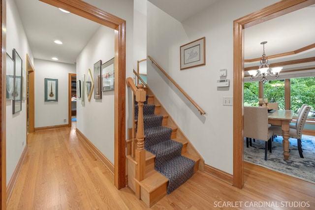 645 Rosewood Dr, West Chicago, IL 60185 - staircase with wood finished floors, a chandelier, baseboards, and recessed lighting
