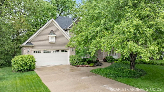 645 Rosewood Dr, West Chicago, IL 60185 - view of front of house featuring a garage, a front yard, driveway, and brick siding