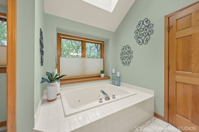 645 Rosewood Dr, West Chicago, IL 60185 - bathroom featuring a skylight, a jetted tub, vaulted ceiling, and baseboards
