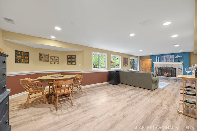 645 Rosewood Dr, West Chicago, IL 60185 - dining space with light wood-type flooring, a brick fireplace, baseboards, and recessed lighting