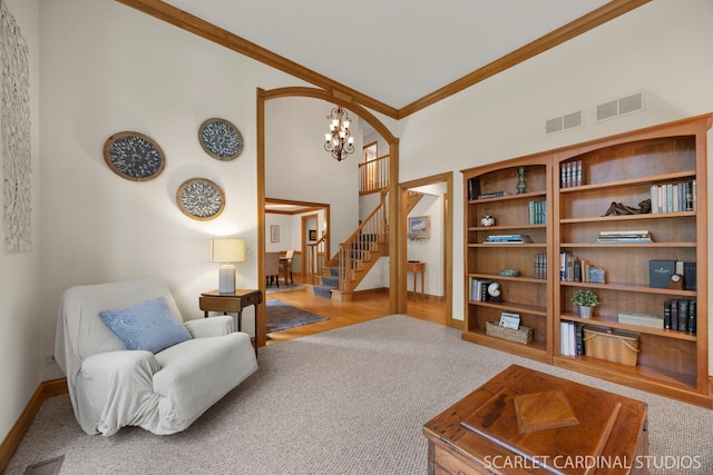 645 Rosewood Dr, West Chicago, IL 60185 - sitting room featuring carpet flooring, a towering ceiling, ornamental molding, a chandelier, and stairs