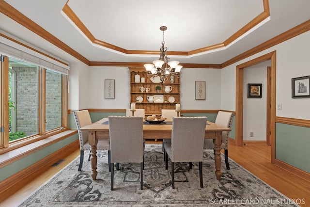 645 Rosewood Dr, West Chicago, IL 60185 - dining space with wood finished floors, a tray ceiling, ornamental molding, a chandelier, and baseboards