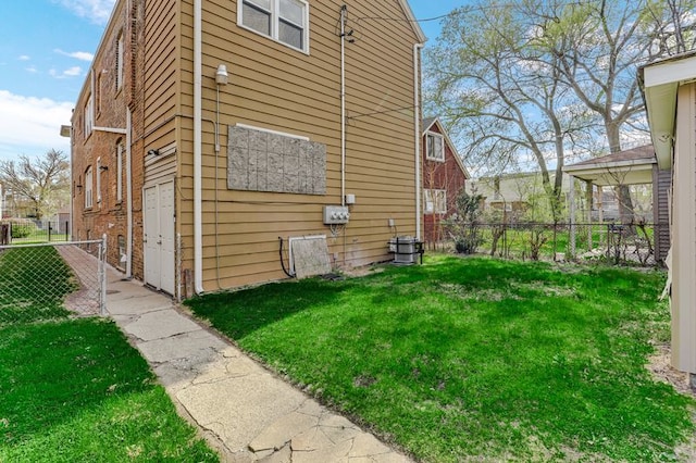 3048 E 80th St, Chicago, IL 60617 - view of property exterior with fence, a lawn, and brick siding