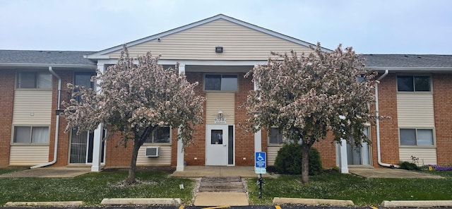view of property featuring uncovered parking
