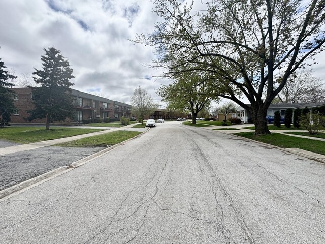 view of road featuring a residential view, sidewalks, and curbs